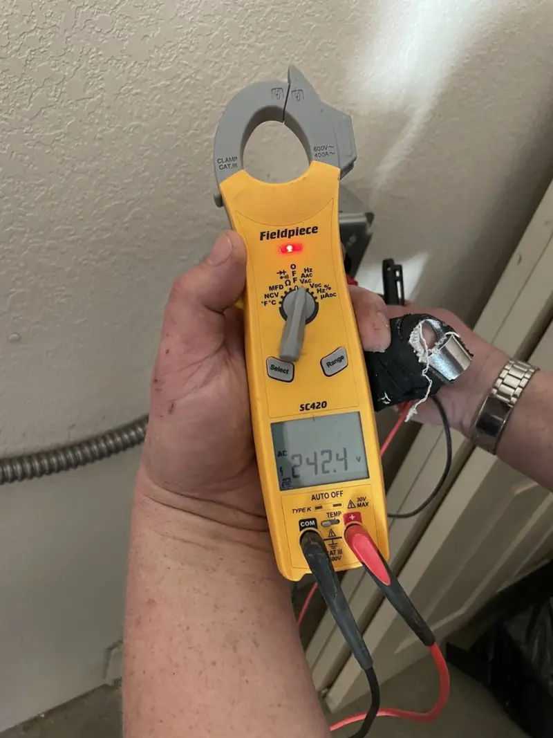 Voltage testing with clamp meter during Outlet Installation in Winslow